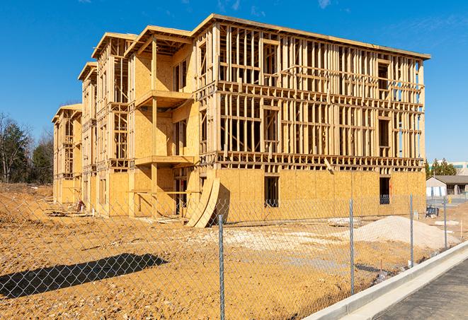 a temporary chain link fence in front of a building under construction, ensuring public safety in Collinsville, OK